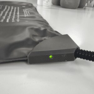 Heat pad showing ON light and start of cable with protective sheath against chewing